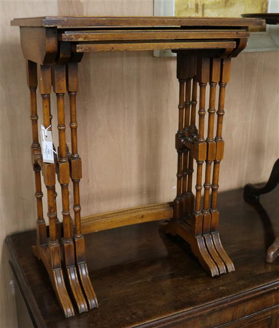 A nest of three yew wood tables W.51cm